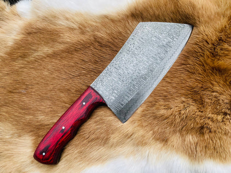 The Knife: Custom Damascus Steel Cleaver Red Handle Chinese Cleaver is a large cleaver with a bold red handle, displayed on a brown and white fur surface.