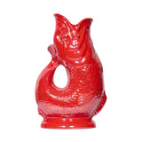 Add a splash of color to your table with the Faire - The Original Gluggle Jug Factory Gluggle Jug Lustre, made in Europe and shaped like a bright red fish with detailed scales and a curved tail handle.