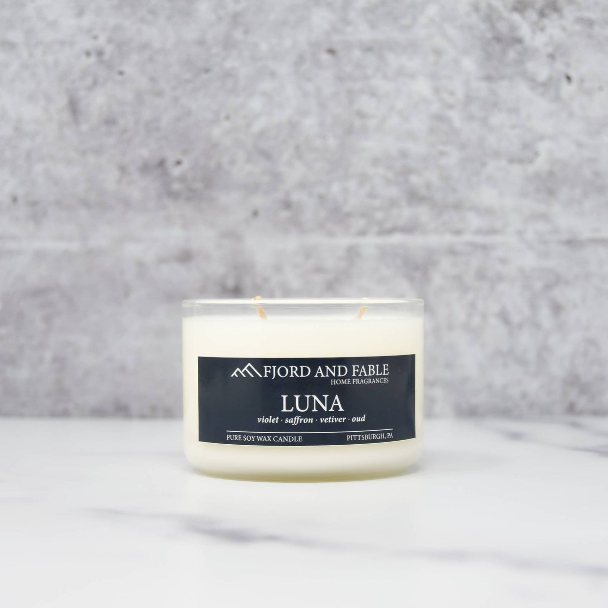 The 8oz Luna Candle by Fjord & Fable features two wicks, over 45 hours of burn time, and comes in a glass jar—perfect for enhancing your home with elegant fragrance.