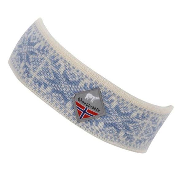 The hat, named the Norlender Headband - Snowflake Blue & White, showcases a classic Norwegian design with a snowflake pattern in blue and white. Crafted in Norway from 100% wool, it flawlessly merges style with genuine craftsmanship.