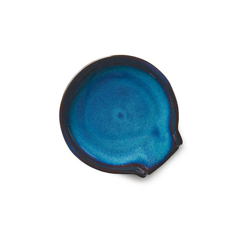 The Spoon Rest: Lake Life Ceramic Round Spoon Rest is a handmade, food-safe ceramic dish with a glossy blue glaze and a small pouring spout, shown on a white background.