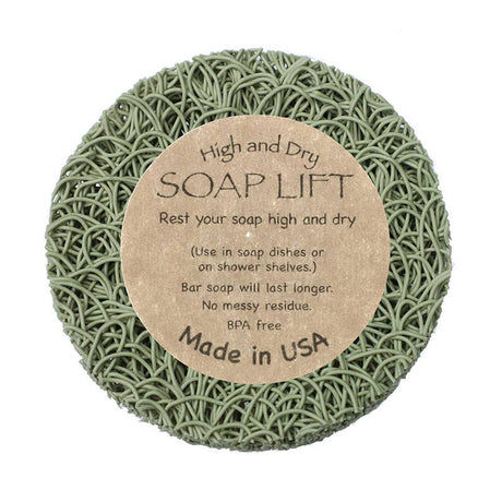Round Sage Soap Lift® with a label that reads: High and Dry SOAP LIFT. Keep your soap elevated on shower shelves. Made in the USA with eco-friendly bioplastic.