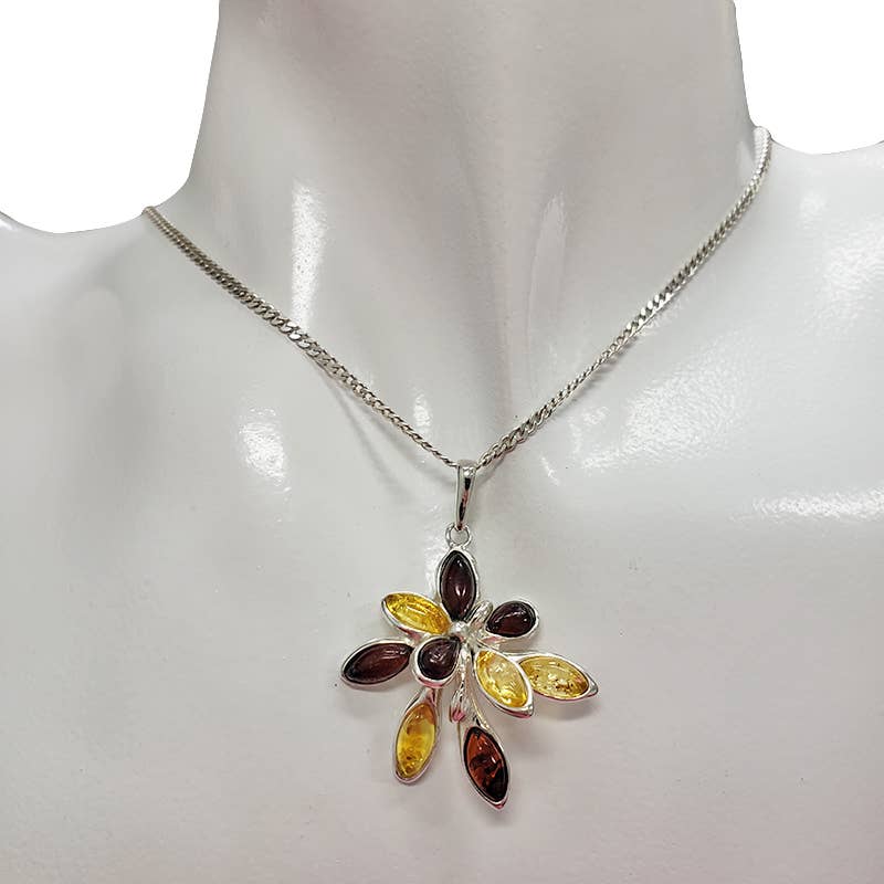 The Pendant: Flower Multi Color Amber Silver Pendant features marquise-cut Baltic amber stones in yellow, orange, and brown on sterling silver, shown on a white mannequin bust.