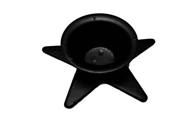 The Candle Holder: Star Wrought Iron Taper Holder, a black star-shaped piece with a recessed round center, stands on a white background, adding a decorative touch that complements any setting.