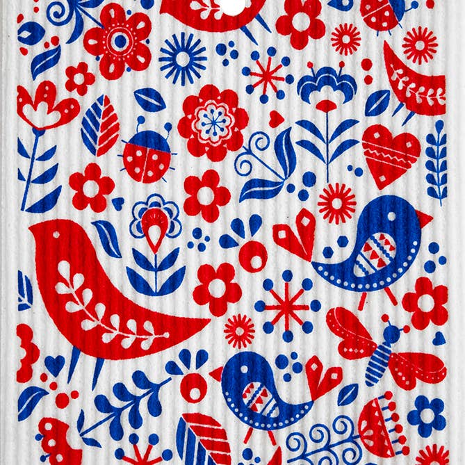 The Birds Bugs & Flowers Swedish Dish Cloth features a vibrant Scandinavian folk art pattern with birds, flowers, leaves, ladybugs, and hearts in red and blue on white. It’s stylish and biodegradable.