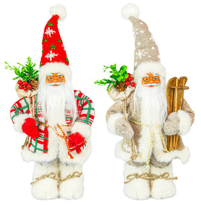 Two Santa figurines, one in beige with skis and green sprigs, the other in red with berry accents; both have fluffy boots and white beards.