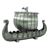 The Figurine: Norwegian Viking Ship with Sail Pewter 5″x3″ Table Decor by Faire - Scandinavian Specialties is a handcrafted keepsake that beautifully captures Scandinavian heritage, featuring a dragon-shaped prow, detailed shields along the side, and a single sail with a small flag atop—expertly crafted in pewter.