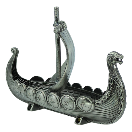 The Figurine: Norwegian Viking Ship with Sail Pewter 5″x3″ Table Decor by Faire - Scandinavian Specialties is a meticulously handcrafted metallic model featuring a dragon-shaped prow, single mast, and intricately detailed shields along the sides—a striking Norwegian keepsake perfect for collectors and history enthusiasts.