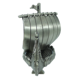 A handcrafted pewter Norwegian Viking ship figurine by Faire - Scandinavian Specialties, featuring a curved hull, decorated prow, and vertical slats forming the sail—this 5″x3″ table decor piece is a front-view keepsake reminiscent of a traditional longship.