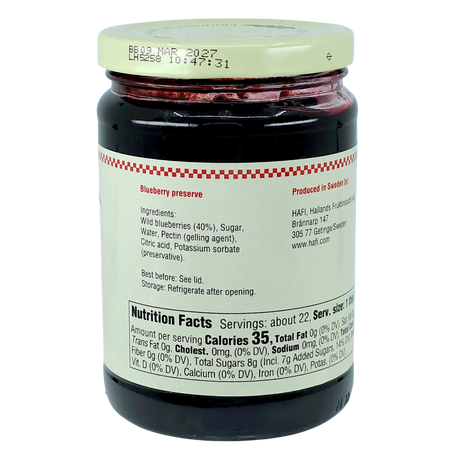 A glass jar of Swedish blueberry preserves with a red lid. The front label displays ingredients, nutrition facts, and company information.