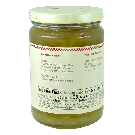 Glass jar of green, chunky gooseberry preserves with a white label displaying ingredients, nutrition facts, and storage instructions.