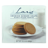 Plate of Swedish ginger snaps beside a glass of milk on a white surface; package labeled Lars Own pepparkakor spiced cookies is visible.