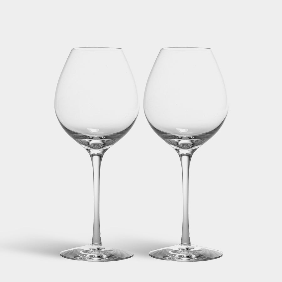 Two mouth-blown wine glasses with long stems stand elegantly on a white background. The Orrefors Difference Fruit Glass (2-Pack) from Sweden is perfect for aromatic white wines and adds sophistication to any setting.