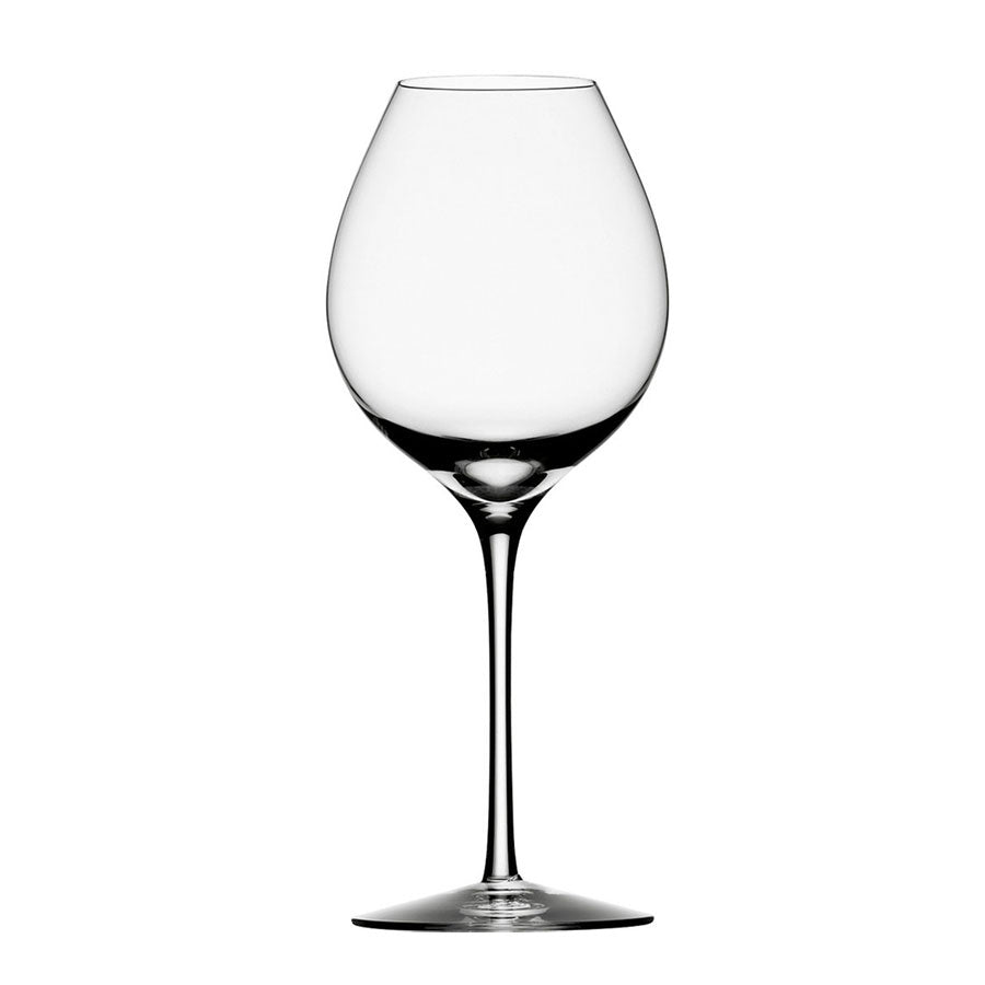 The Orrefors Difference Fruit Glass, a mouth-blown Swedish masterpiece, stands elegantly upright against a plain white background. Its long stem and wide bowl enhance aromatic white wines, highlighting every subtle fruity note. Available in a convenient 2-pack.