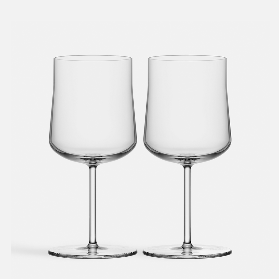 Two empty Orrefors Informal Glass Small 9.5oz glasses stand side by side with tall stems on a plain white background, echoing an elegant Scandinavian design.