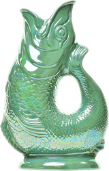 The Gluggle Jug Lustre, made in Europe, is a glossy green ceramic jug shaped like a fish with its mouth open and a curved body that forms the handle.