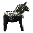 The Dala Horse: Black & Silver "Celebrate Series" by Grannas Olsson is a 13 cm handcrafted Swedish figurine, featuring silver patterns on black wood and inspired by traditional folk art.