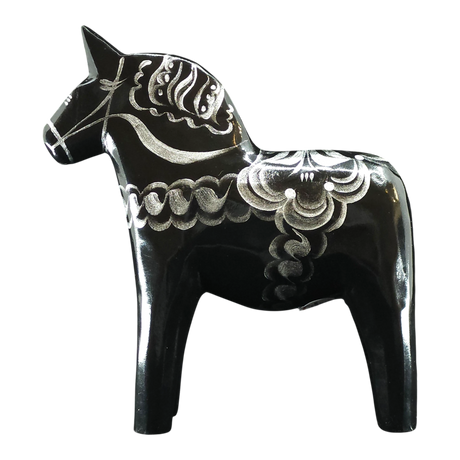 The Grannas Olsson Dala Horse: Black & Silver "Celebrate Series" is a 13 cm Swedish figurine, handcrafted in wood with silver decorative patterns, standing on four legs. Made by Grannas Olsson in Sweden.