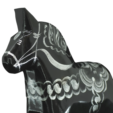 A close-up of the Grannas Olsson Black & Silver Swedish Dala Horse "Celebrate Series" (13 cm), handcrafted in Sweden, featuring detailed silver patterns on its body, displayed against a plain white background.