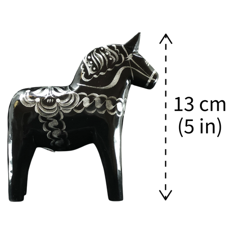 The Grannas Olsson "Celebrate Series" Black & Silver Swedish Dala Horse is a handcrafted 13 cm (5 in) figurine inspired by traditional folk art, featuring decorative patterns.