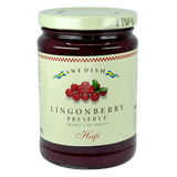 A jar with a cream label showing lingonberries and blue and yellow Swedish flags, referencing Scandinavian heritage.