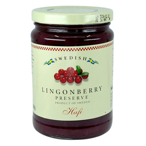 A jar with a cream label showing lingonberries and blue and yellow Swedish flags, referencing Scandinavian heritage.