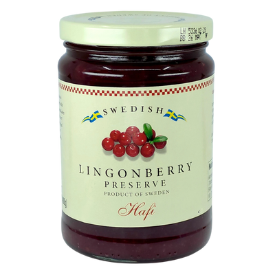 A jar with a cream label showing lingonberries and blue and yellow Swedish flags, referencing Scandinavian heritage.