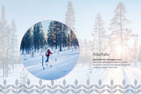 A person cross-country skiing in a snowy pine forest, beside the definition of friluftsliv, illustrating how Nordic Wisdom: Simplify Your Life & Cultivate Well-Being by Elisabeth Carlsson inspires balance and well-being through Nordic lifestyle.