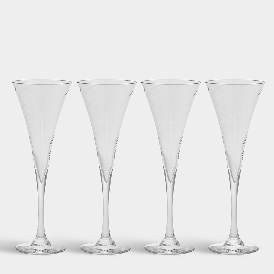 A set of four Orrefors: Helena Champagne Glasses, 8.5oz each, featuring elegant and tall conical designs with slender stems, reminiscent of Gunnar Cyréns iconic style, is displayed against a plain background.