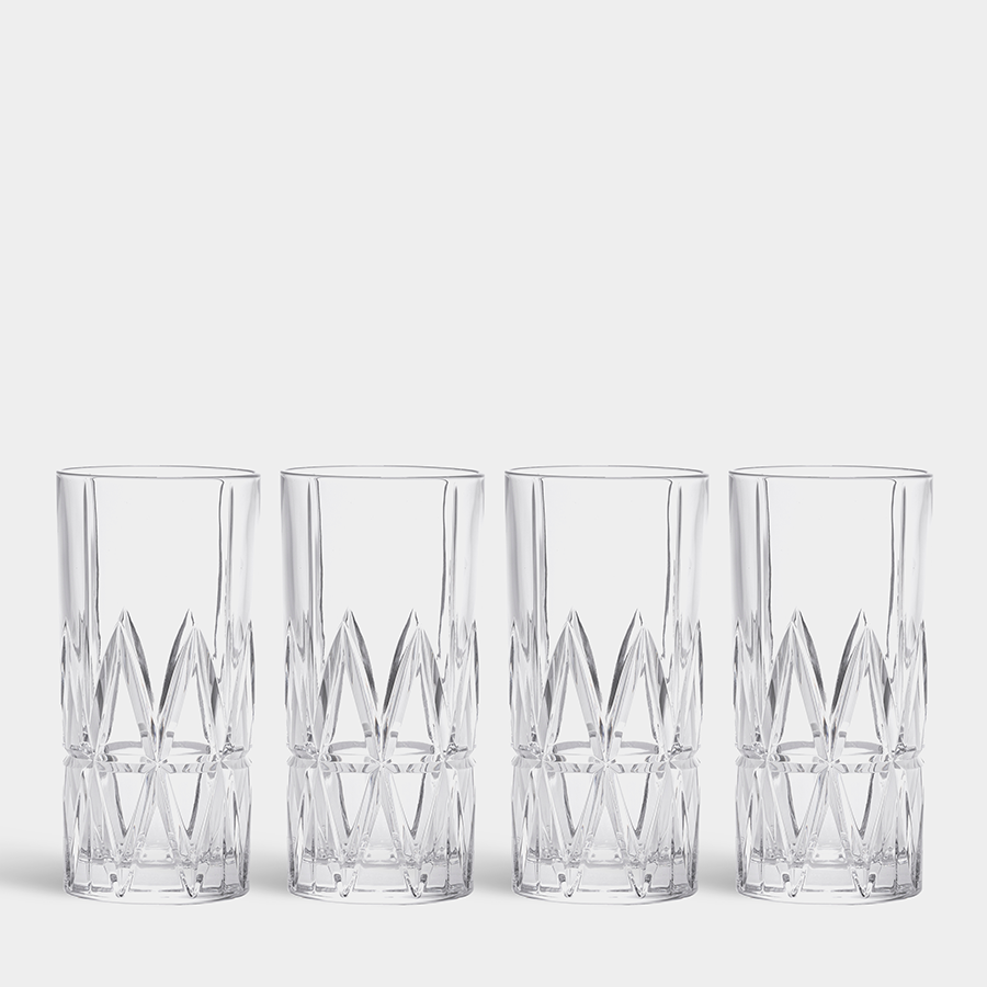 Four Orrefors Peak highball glasses, each 12.5oz and designed by Martti Rytkönen with a geometric pattern, are elegantly displayed in a row against a plain background.