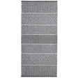 The Mixed Alice rug in grey, made from a cotton and vinyl blend, features a rectangular design with alternating striped and diamond patterns in black and white, suitable for both indoor and outdoor settings.