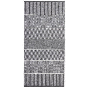The Mixed Alice rug in grey, made from a cotton and vinyl blend, features a rectangular design with alternating striped and diamond patterns in black and white, suitable for both indoor and outdoor settings.