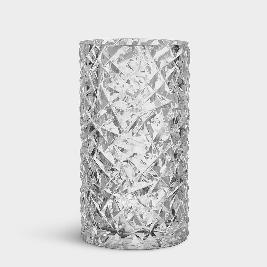 The Orrefors Carat Hurricane vase features a sleek cylindrical shape with a clear textured crystal glass design against a plain white background.