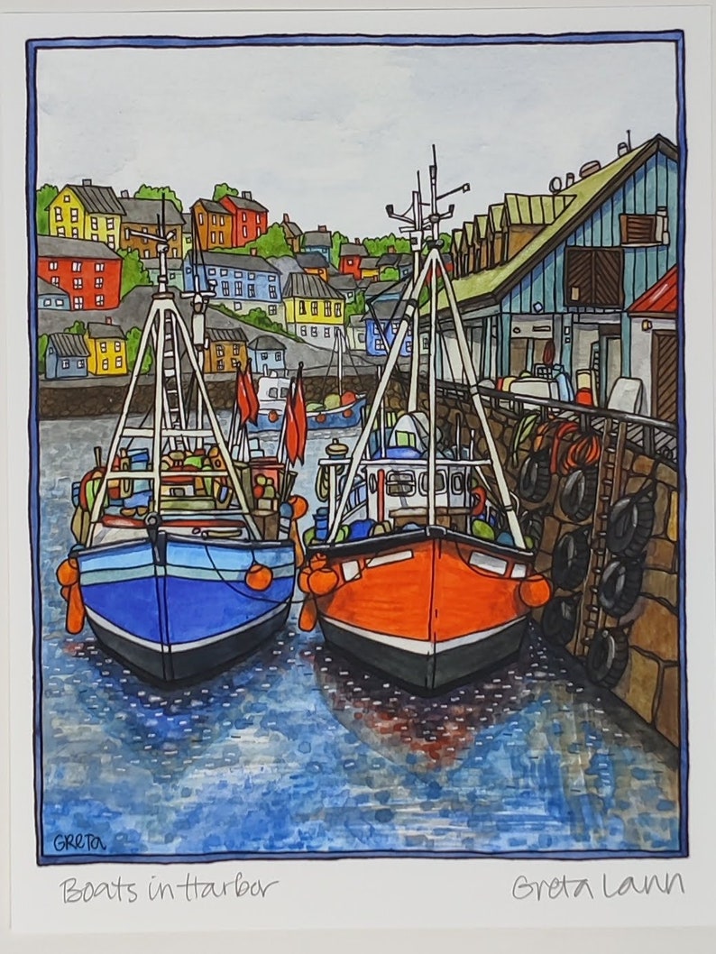 A vibrant illustration titled Boats in Harbor by Greta Lann (11.5x16) depicts two fishing boats docked at a Scandinavian harbor against multicolored buildings and a wooden pier.