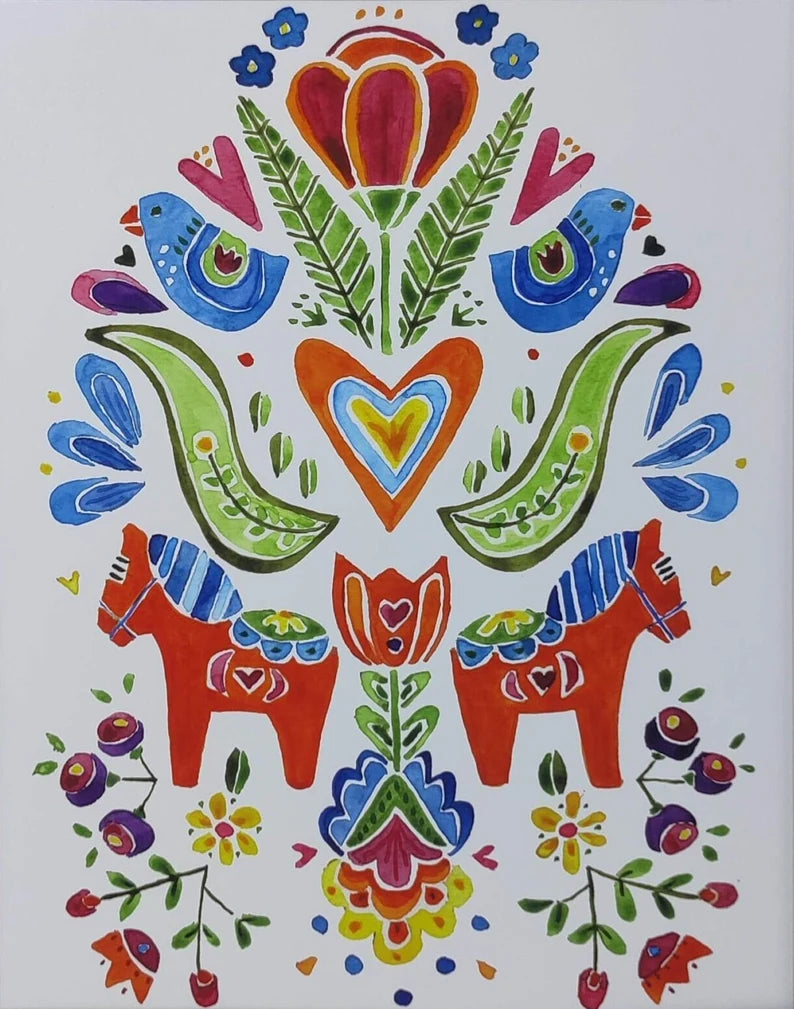 Spring Folk Horses" by Greta Lann is a framed artwork showcasing a watercolor print with an intricate folk art design. It features a vibrant arrangement of birds, colorful flowers, and two symmetrically arranged red folk horses in lively patterns of blue, green, red, and orange.