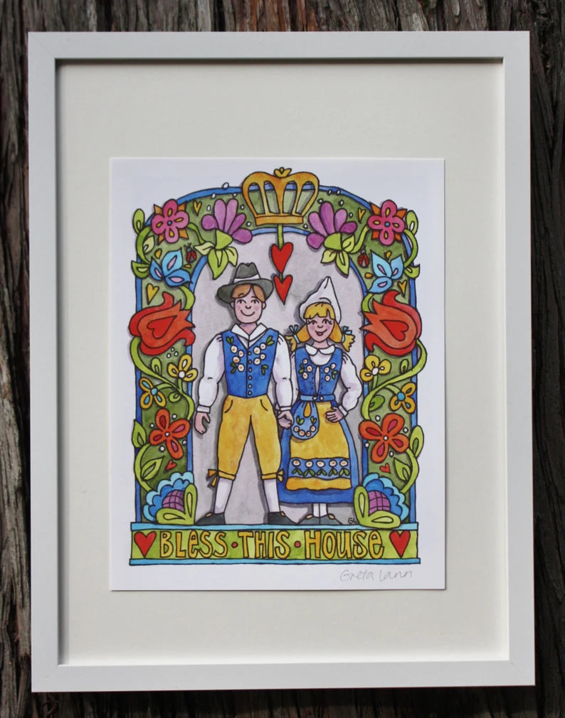 Bless This House 8x10 print by Greta Lann features a couple in national costume, surrounded by colorful flowers and hearts in folk art style, with the phrase Bless This House at the bottom.