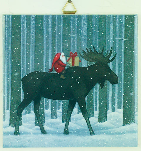 Illustration of Santa holding a gift, riding a moose through a snowy forest with tall trees, captured on the 6" Ceramic Tile titled "Moose in Tall Trees" by Eva Melhuish.