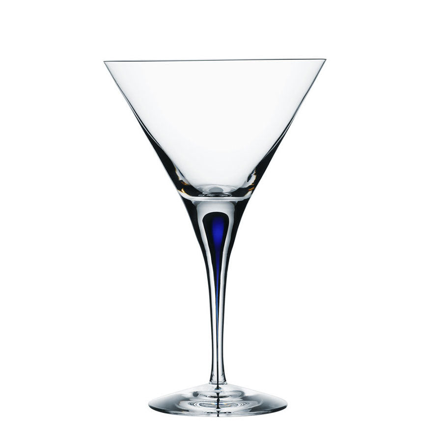 The Orrefors Intermezzo Blue Martini Glass 8.5oz (2-Pack) by Erika Lagerbielke showcases a distinctive blue tint at the base, elegantly set against a pristine white background, epitomizing artistry and elegance.