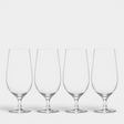 A set of four Orrefors Beer Lager 20oz glasses, designed by Erika Lagerbielke, is arranged in a row against a plain white background.