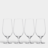 A set of four Orrefors Beer Lager 20oz glasses, designed by Erika Lagerbielke, is arranged in a row against a plain white background.