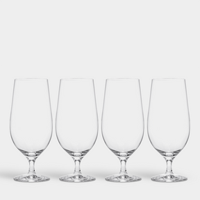 A set of four Orrefors Beer Lager 20oz glasses, designed by Erika Lagerbielke, is arranged in a row against a plain white background.