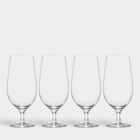 A set of four Orrefors Beer Lager 20oz glasses, designed by Erika Lagerbielke, is arranged in a row against a plain white background.