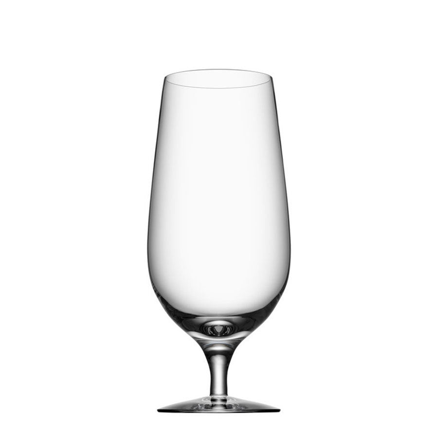 The Orrefors Beer Lager 20oz (4-Pack) glass, with its narrow stem, stands elegantly against a white background, epitomizing Erika Lagerbielkes sophisticated design style.