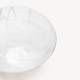 The KostaBoda Contrast Bowl by Anna Ehrner features white glass with blue and black veining, shown on a plain white background.