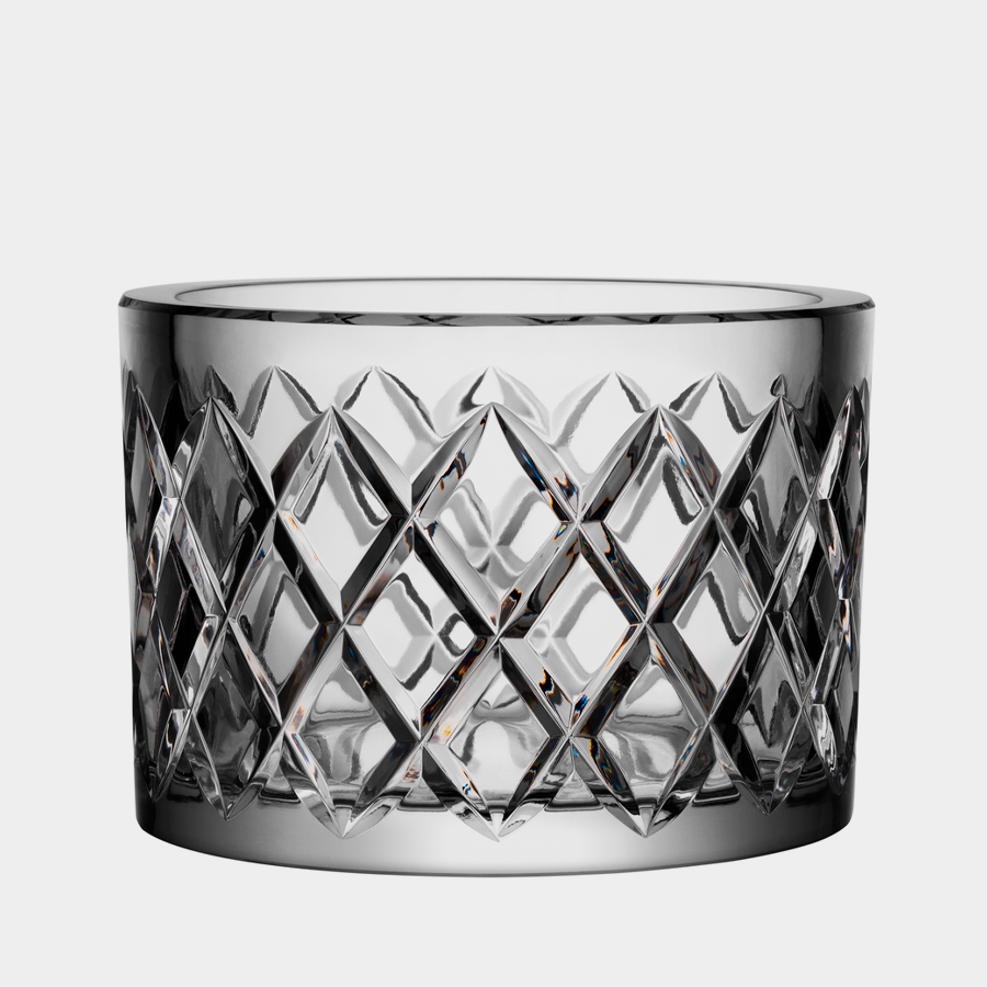 A large clear glass bowl, Orrefors: Legend Bowl Checkered, features a geometric diamond pattern with a cylindrical shape.