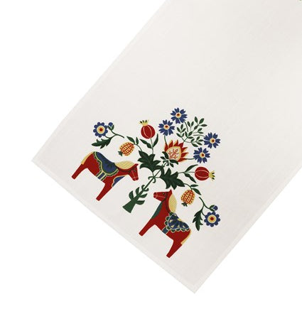 The Table Runner: Dala Horse and Kurbits (40x120cm) features white fabric with two red Dala horses and colorful flowers—perfect for adding Swedish folk art charm to your Scandinavian décor.