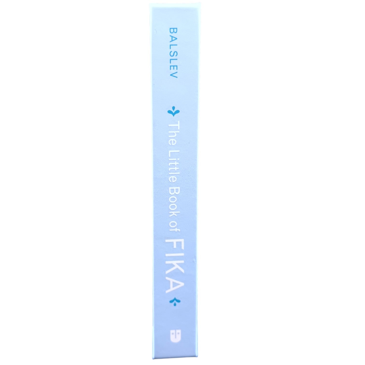 The spine of a light blue Book: Little Book of Fika by Lynda Balslev stands upright against a white background, inviting readers to explore the Swedish coffee break tradition.