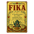 Vintage metal sign with the word FIKA, its pronunciation, and a definition of a Swedish coffee break, illustrated with a teapot, two mugs, and a cinnamon bun.