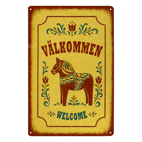 Rectangular metal sign featuring a Dala horse, floral rosemaling patterns, and the text VÄLKOMMEN and WELCOME.