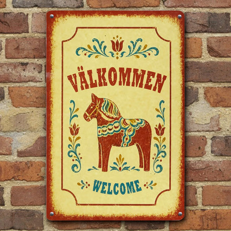 Swedish welcome sign featuring a painted Dala horse, floral patterns, and the words “VÄLKOMMEN” and “WELCOME,” displayed on a brick wall.